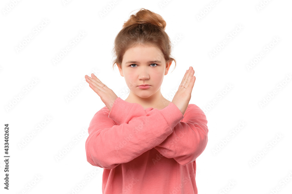 close up serious-looking determined teen girl making stop sign with crossed hands, saying stop close up serious-looking determined teen girl making stop sign with crossed hands, saying stop