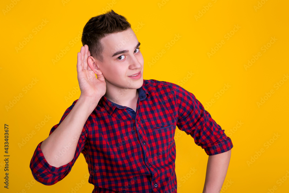 A handsome guy in a red shirt on a yellow background A handsome guy in a red shirt on a yellow background