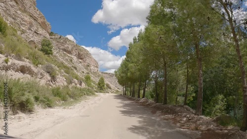 Car Mount Point of View. Driving through a narrow mountain road on sunny day. Canyon Jucar. Albacete, Spain. photo