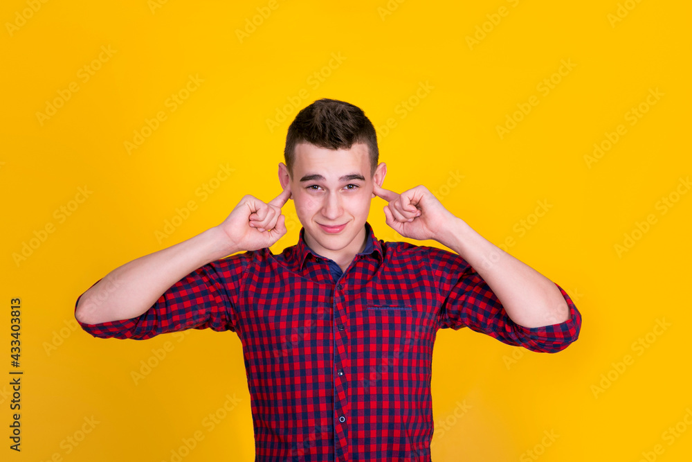 A handsome guy in a red shirt on a yellow background A handsome guy in a red shirt on a yellow background