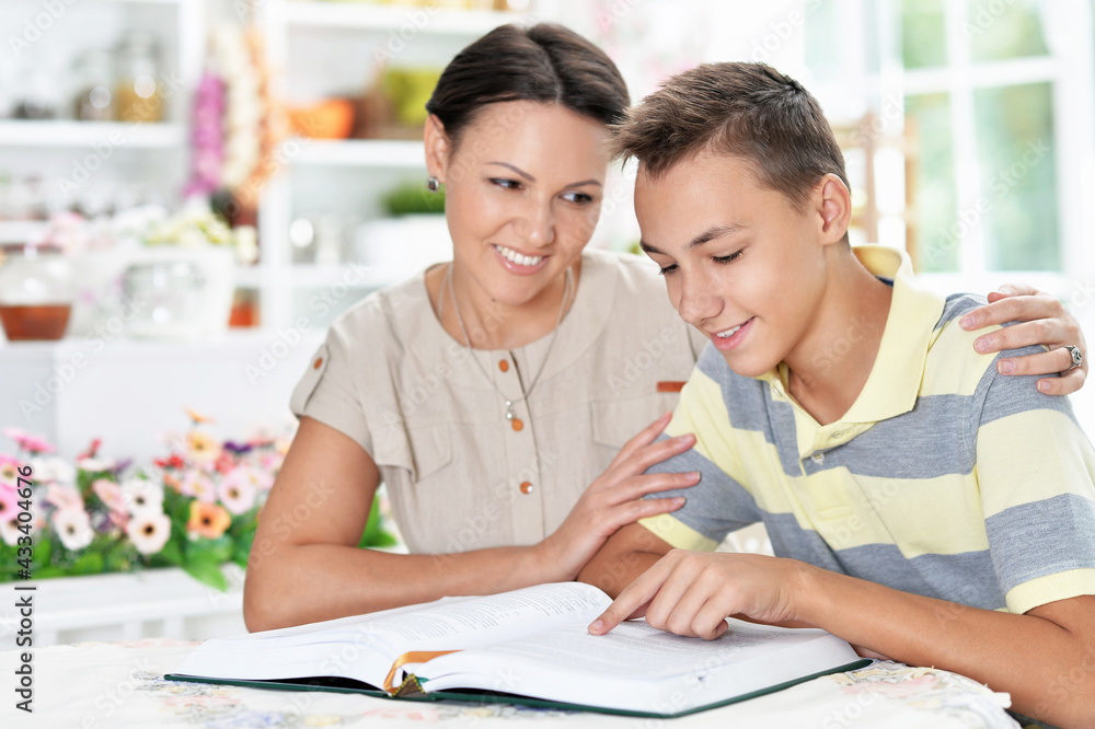 Emotional mother with her son doing homework at home Emotional mother with her son doing homework at home