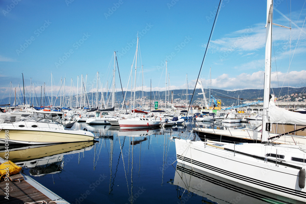 Many boats and yahts, floating ship in marina. Bay landscape with blue sea, resort city. Harbor and sailboats, moored. Outdoors, copy space.