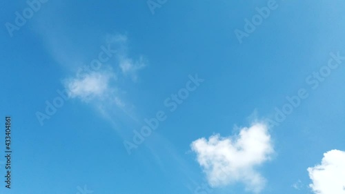 Time Lapse of beautiful sunny blue sky background with white fluffy clouds and cirrus cloudscape skyline motion on bright daylight horizon and sun ray in beautiful tropical summer season 