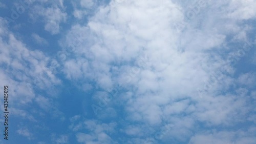 Time Lapse of beautiful sunny blue sky background with white fluffy clouds and cirrus cloudscape skyline motion on bright daylight horizon in beautiful tropical summer season 