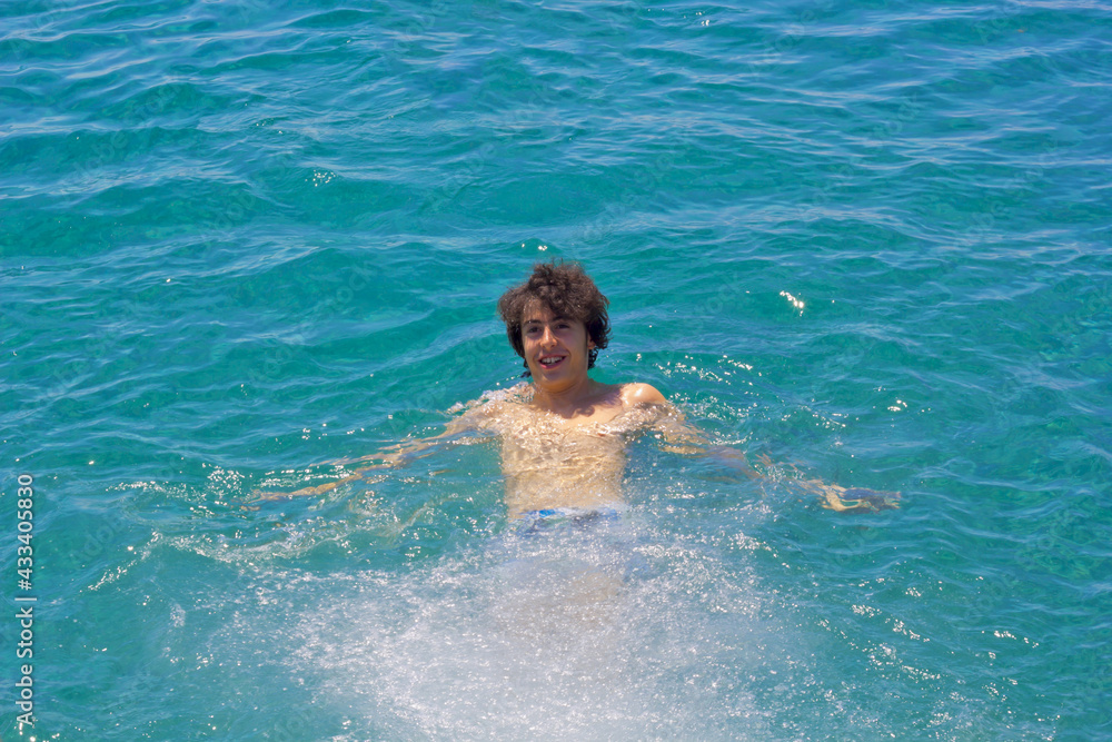 happy boy in swimming in the sea in sigacik, Turkey