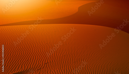 Orange ripple sand dune desert at sunset