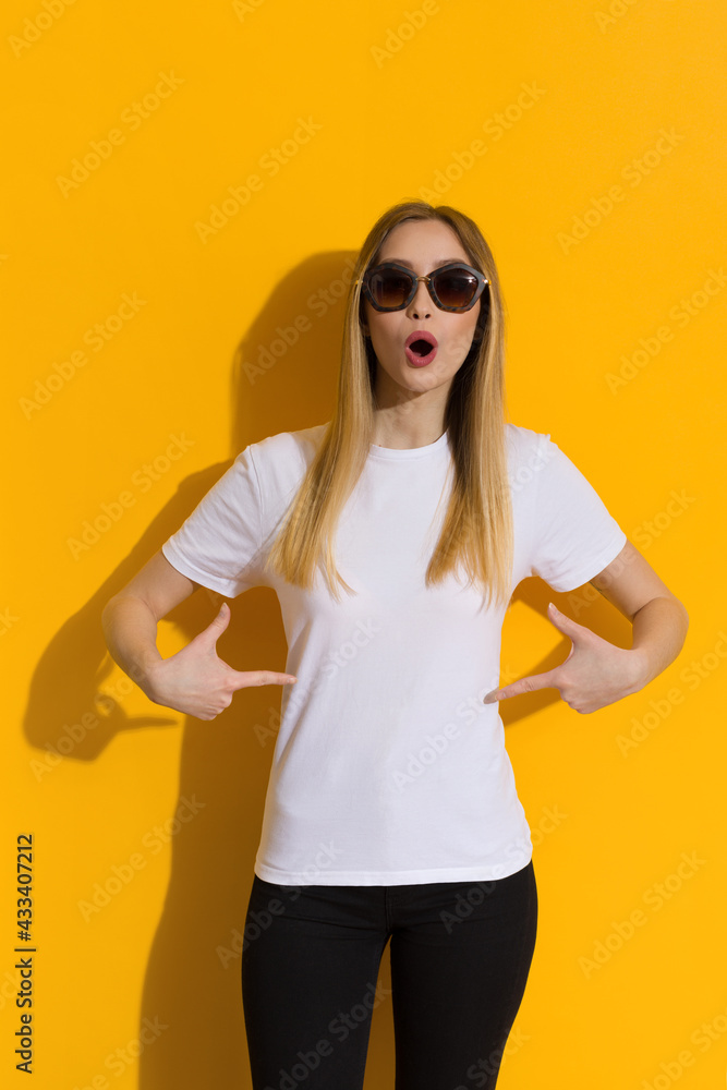Surprised Girl In Sunglasses Is Pointing At Her White Shirt Surprised Girl In Sunglasses Is Pointing At Her White Shirt