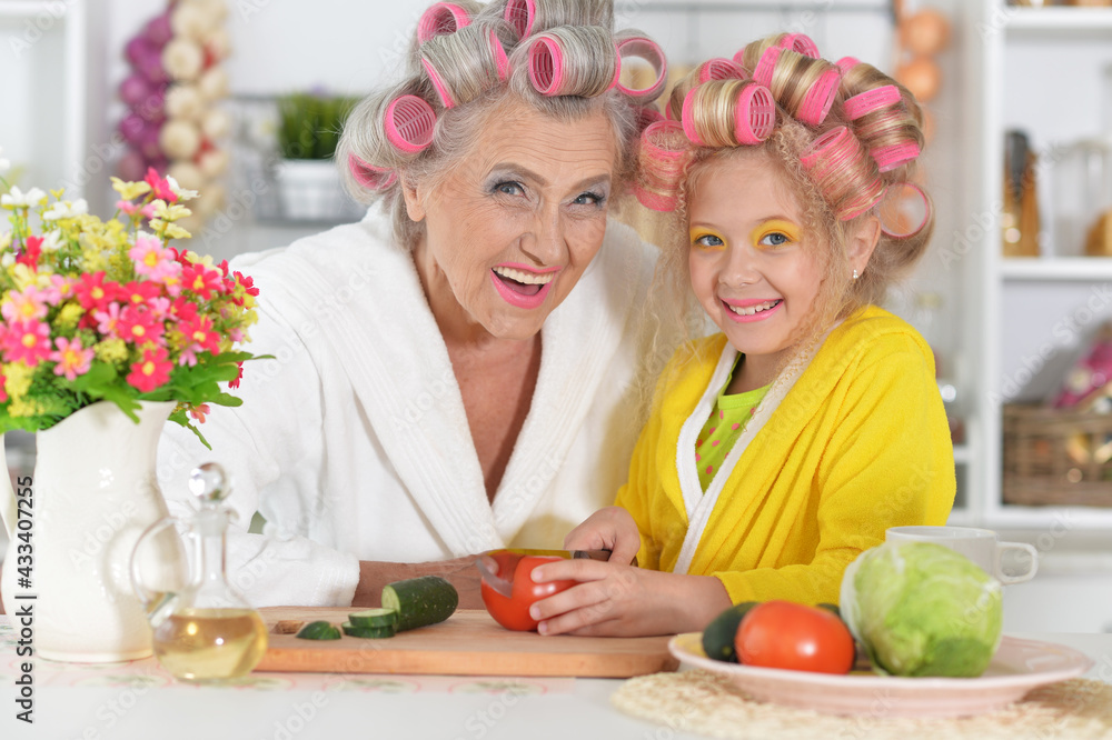 Senior woman and granddaughter at kitchen Senior woman and granddaughter at kitchen
