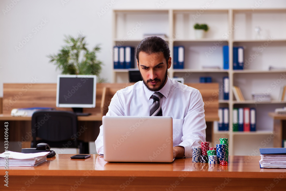 Young male employee in gambling concept Young male employee in gambling concept