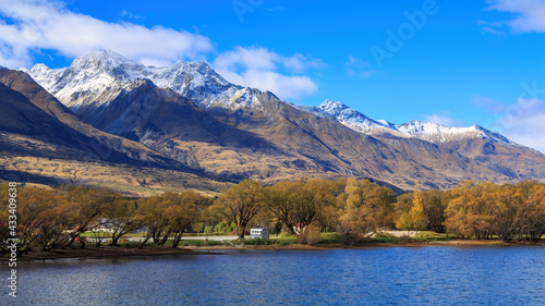 Fototapeta Naklejka Na Ścianę i Meble -  Autumn landscape at Glenorchy in the South Island of New Zealand. Lake Wakatipu, fall willow trees on the Glenorchy waterfront, and the mountains of the Southern Alps