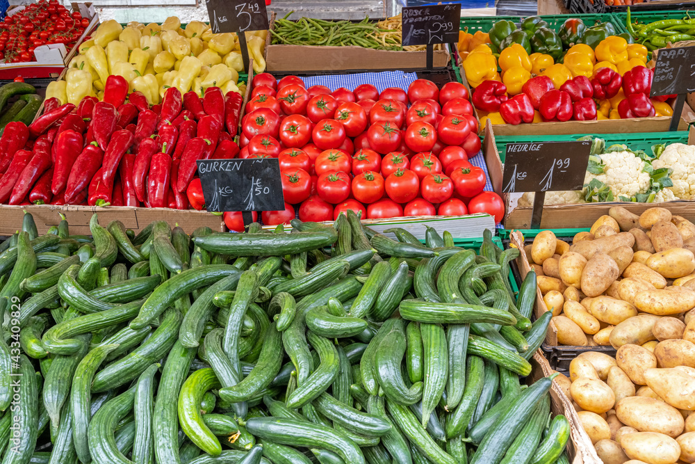 Cucumber, tomatoes and potatoes for sale at a market