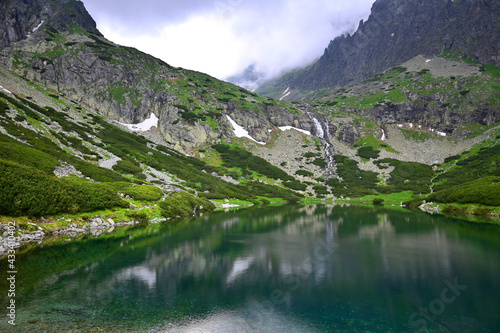 Landscape of the High Tatra mountains. Lake Velicke pleso  waterfall Velicky vodopad and mountains. Slovakia.