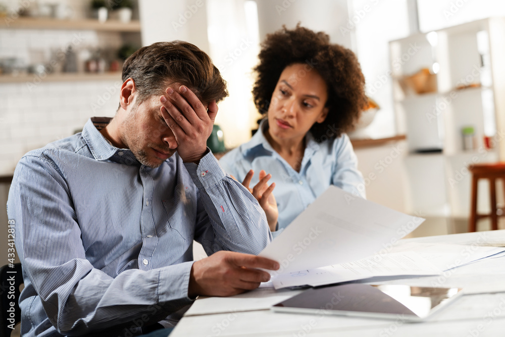 Young couple preparing bills to pay. Stressed woman and man having financial problems... Young couple preparing bills to pay. Stressed woman and man having financial problems...