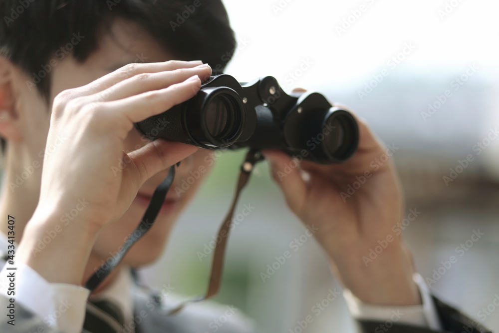 Close up of businessman looking through binoculars Close up of businessman looking through binoculars