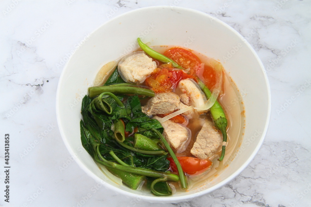 Filipino food called Pork Sinigang or pork and vegetables in tamarind broth Filipino food called Pork Sinigang or pork and vegetables in tamarind broth