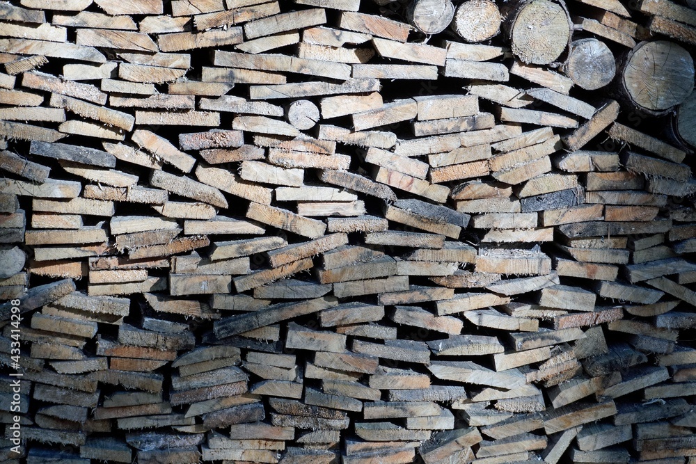 The ends of the stacked firewood for a fireplace or barbecue. Texture. Background The ends of the stacked firewood for a fireplace or barbecue. Texture. Background