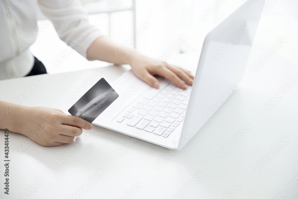 Woman shopping online with credit card Woman shopping online with credit card