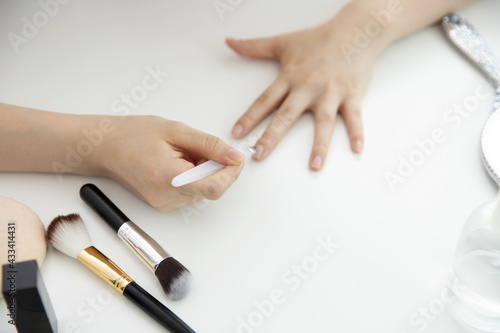 Close up of woman using cuticle pusher