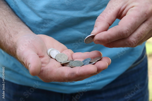 Fototapeta person putting coin into a coin