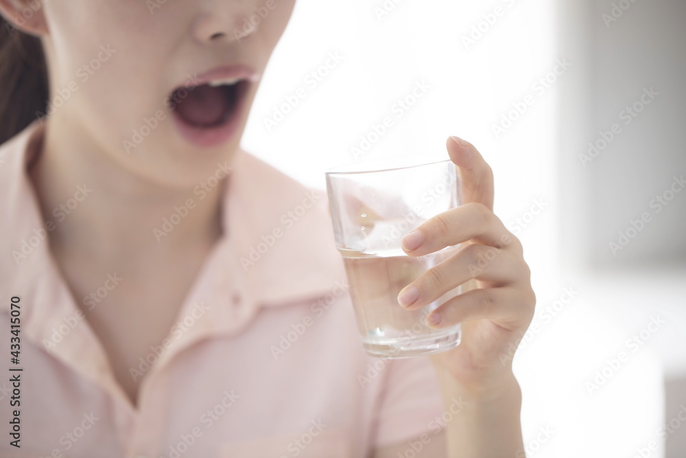 Close up of young woman drinking glass of water Close up of young woman drinking glass of water
