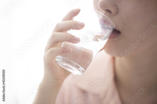 Woman drinking water from glass,close up