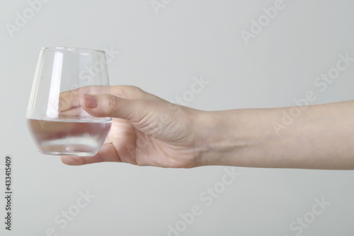 Close up of woman holding glass of water © 상은 신