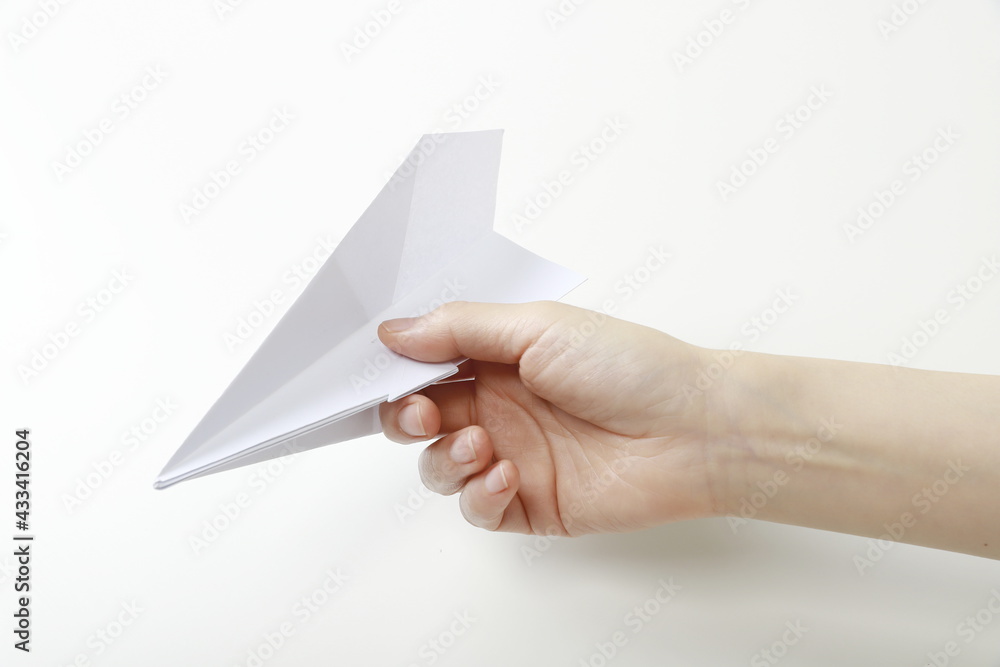Close up of woman holding paper airplane Close up of woman holding paper airplane