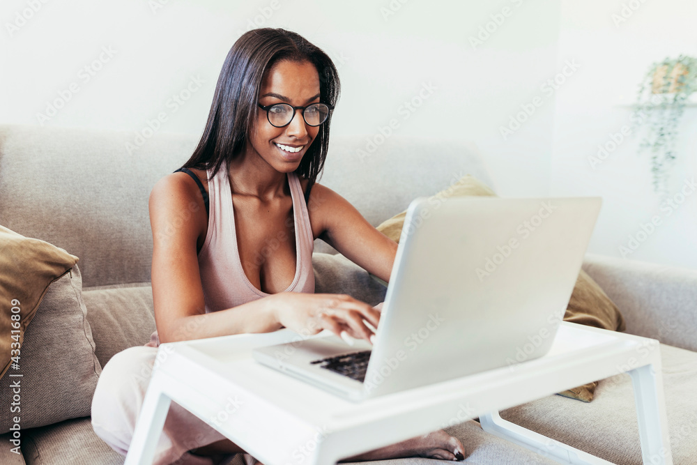 Young mixed race woman working from home with laptop Young mixed race woman working from home with laptop