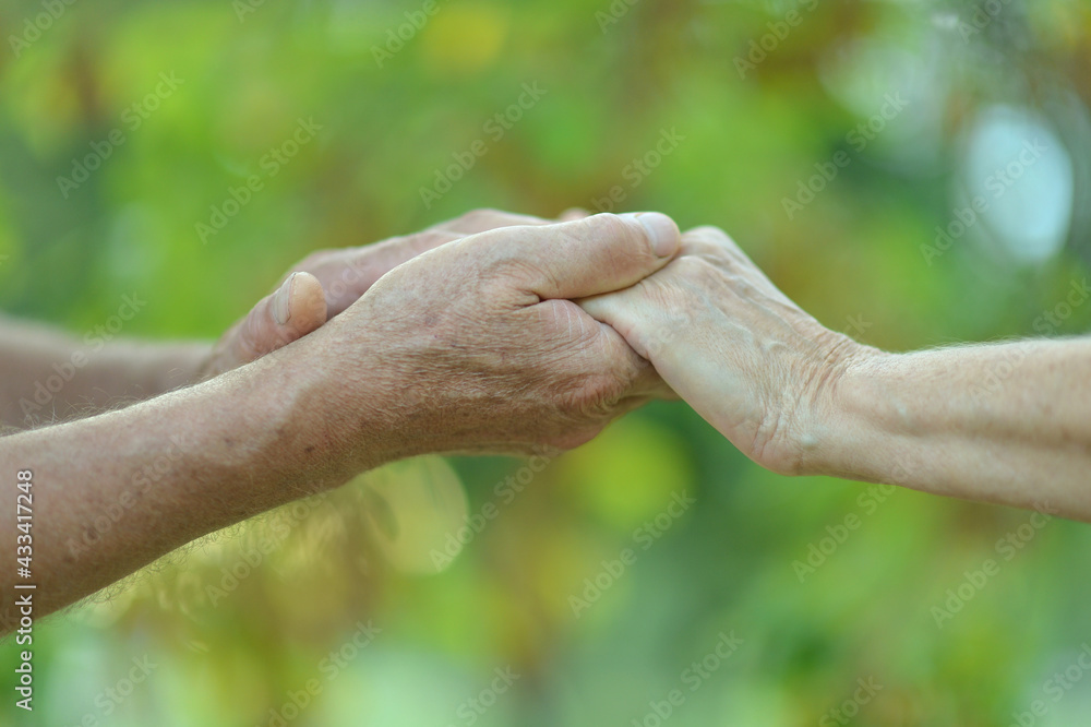 Fototapeta premium Couple holding hands together