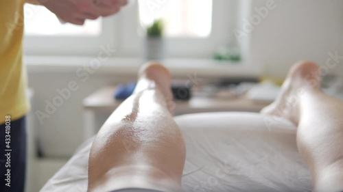 Wallpaper Mural The masseur treats the athlete's leg with alcohol and wipes with a towel that would glue the tap. Torontodigital.ca