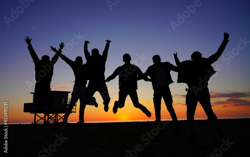 people jumping on the background of the sunset © Dmitrii