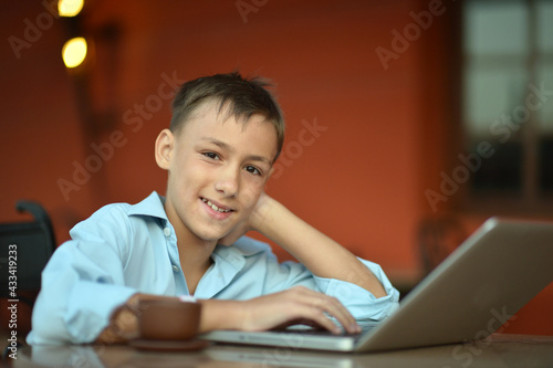 Cute boy using laptop computer