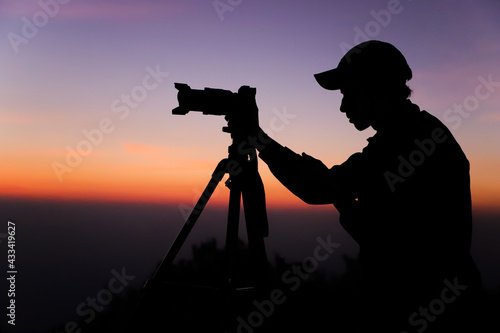 Photography Silhouette of the photographer with tripod