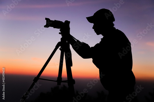 Photography Silhouette of the photographer with tripod