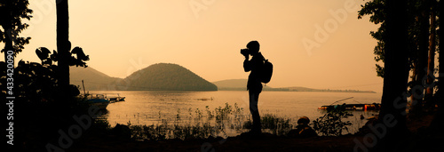Canvas Print Silhouette of a lone photographer in nature