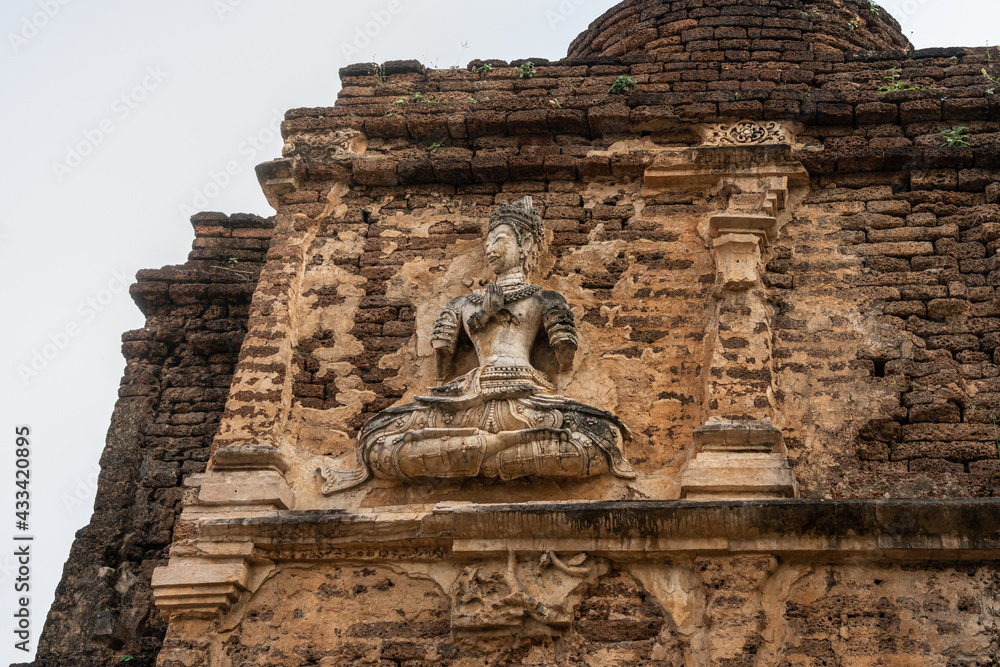 Angel statue on the outer wall of Wat Chet Yot Pagoda which has decayed over time, it was built in 1455.