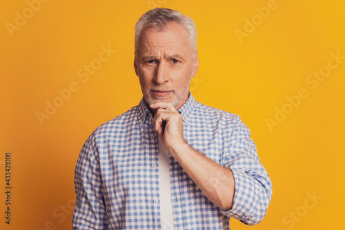 Canvas Print Aged man with hand on beard looking up thinking