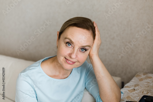An adult woman looks happily into the camera. Portrait. © Елизавета Лукашевич