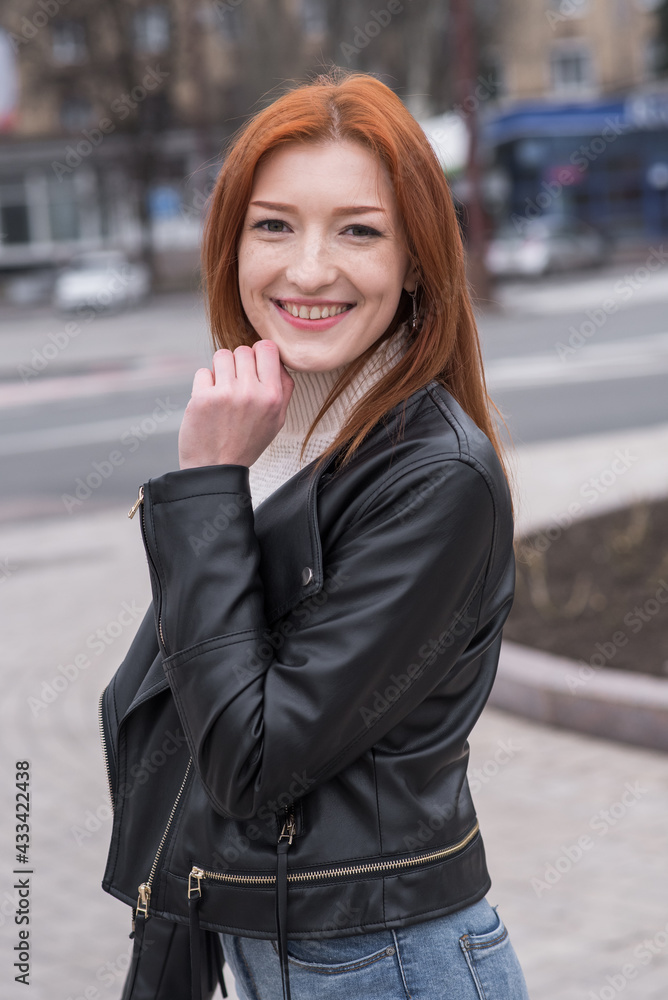 Portrait of a beautiful and positive redhead woman with clothes in grunge style. Posing while walking Portrait of a beautiful and positive redhead woman with clothes in grunge style. Posing while walking
