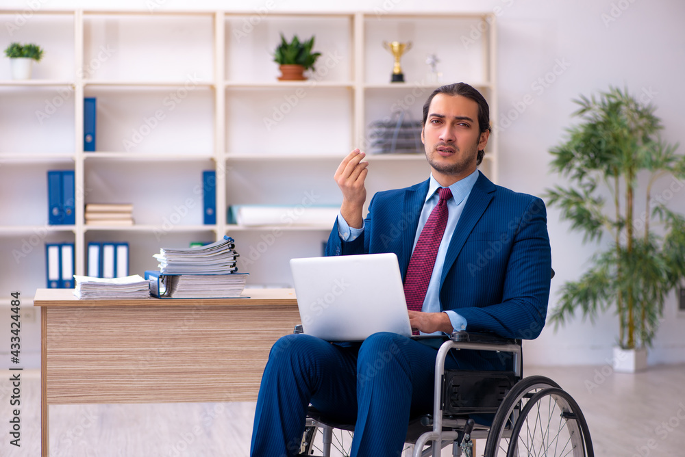 Young disabled employee working in the office Young disabled employee working in the office