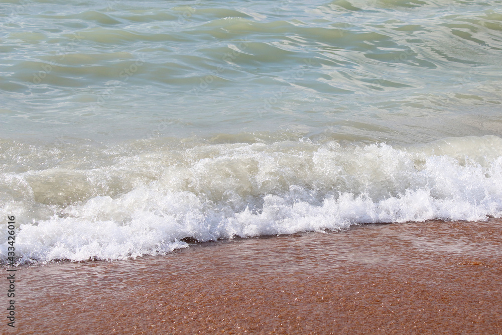 Sea. Small wave. Close-up. Beach. Background. Texture. Scenery.