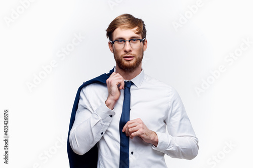 cute businessman in glasses with a jacket on his shoulder and tie shirt model