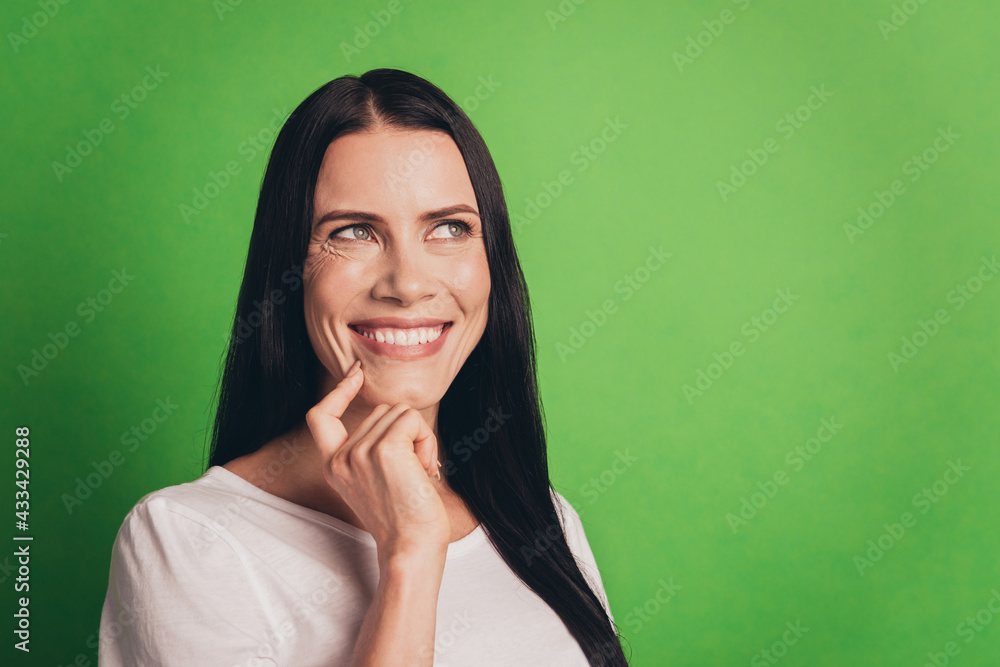 Young thoughtful girl touch chin hand dreaming on green background Young thoughtful girl touch chin hand dreaming on green background