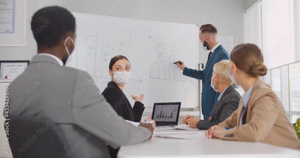 Diverse business team at training in medical face mask Diverse business team at training in medical face mask