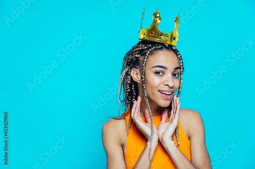 Cuadro en lienzo Beautiful girl with pigtails making party on a blue colored background