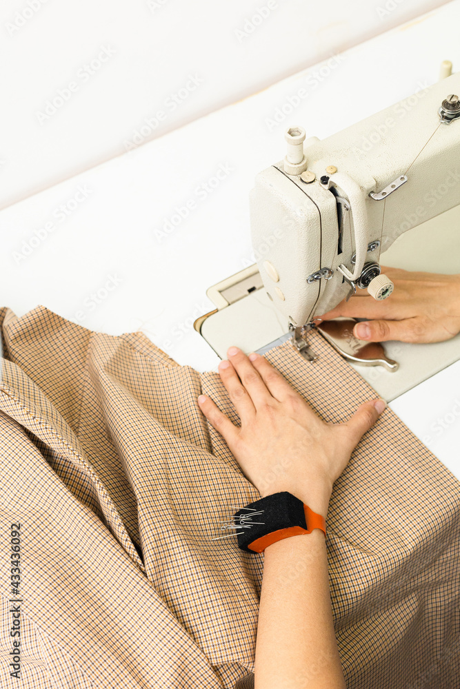 Sewing machine and fabric on a light background