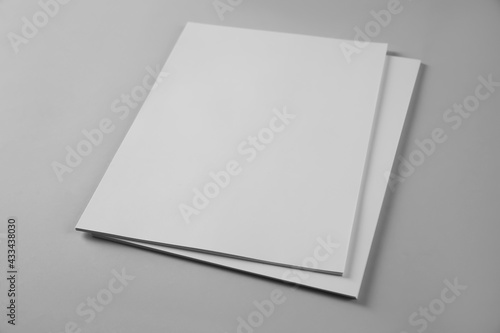 Blank brochures on grey background. Mockup for design