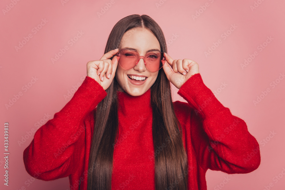 Photo of youngster girl good mood winking eye flirt isolated over pink background Photo of youngster girl good mood winking eye flirt isolated over pink background