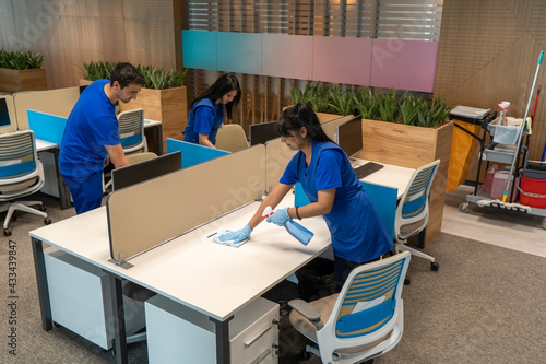 
Group of cleaners clean an empty office space