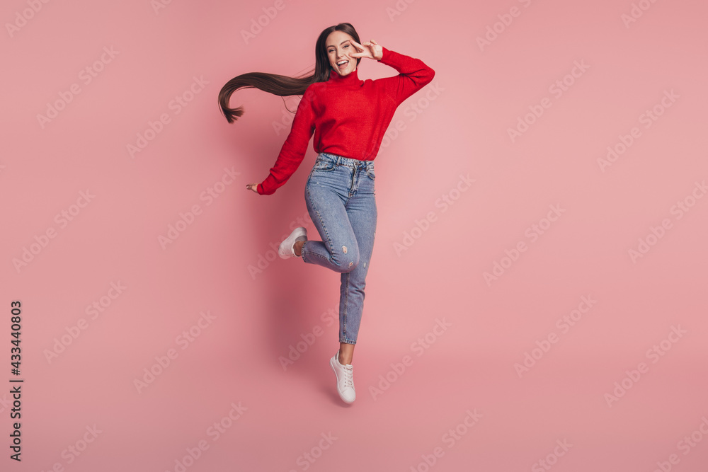 Full size photo of jumping high lady v-signing positively wear casual clothes Full size photo of jumping high lady v-signing positively wear casual clothes
